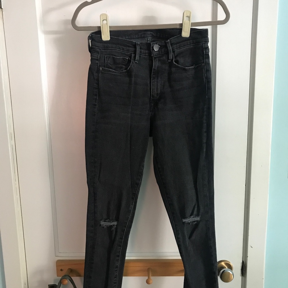 Black BDG jeans with frayed hem.